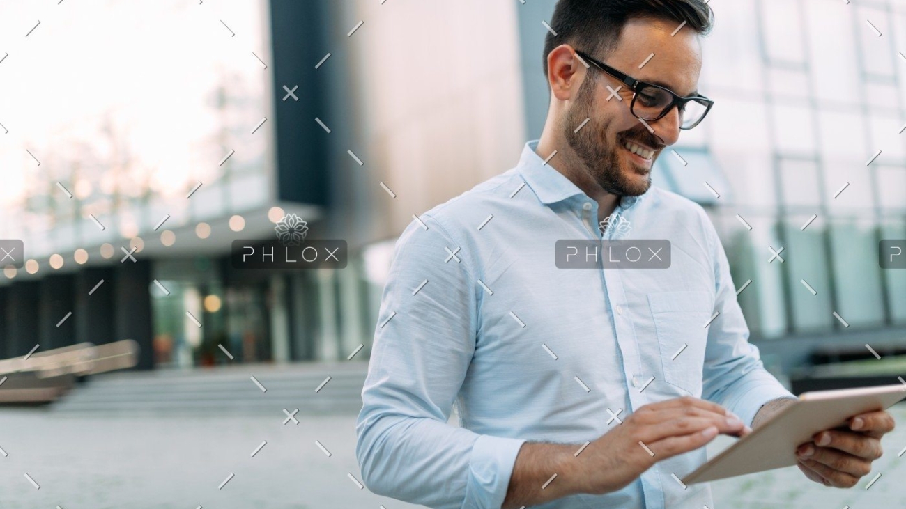 demo-attachment-1482-portrait-of-businessman-in-glasses-holding-tablet-AWVHCJU